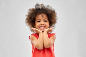 Smiling toddler pictured against neutral background