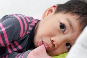Young child sucking his thumb