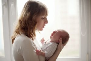 Mother trying to comfort her crying infant 